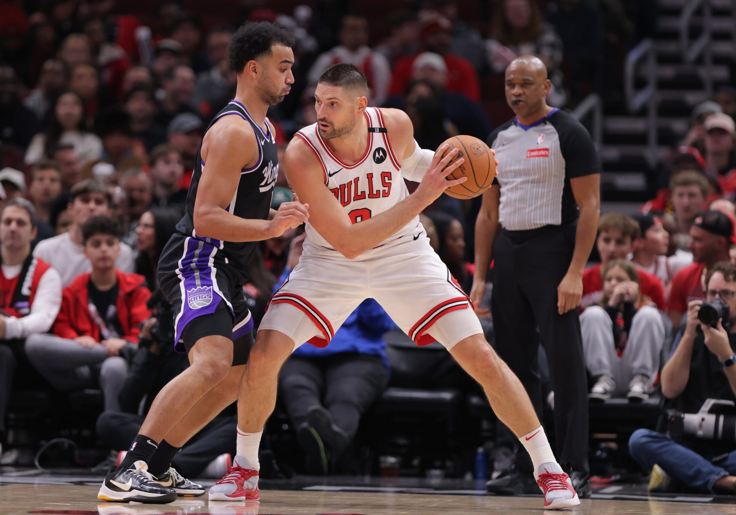 Trey Lyles #41 of the Sacramento Kings posts up against Nikola Vucevic #9 of the Chicago Bulls during the second half on January 12, 2025 at the United Center in Chicago, Illinois.