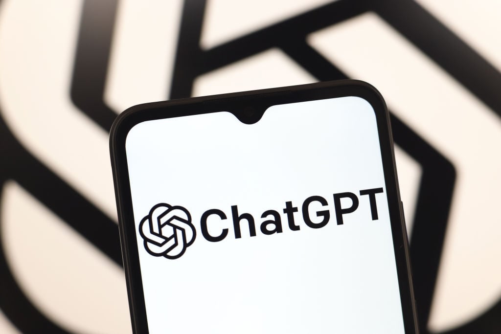 The chatgpt logo on a smartphone in front of the openai logo