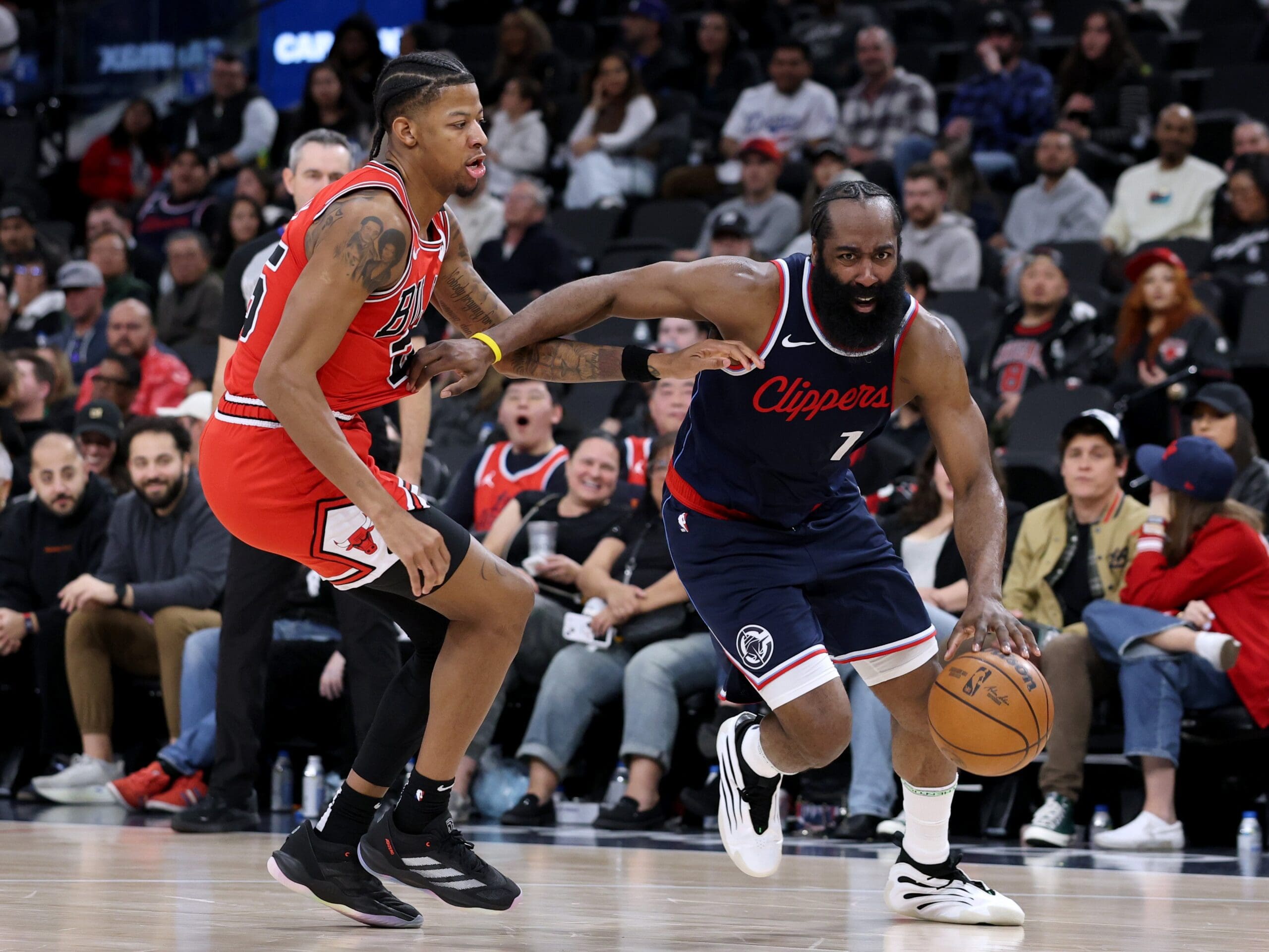 James Harden #1 of the LA Clippers drives to the basket on Dalen Terry #25 of the Chicago Bulls during a 112-99 Bulls win at Intuit Dome on January 20, 2025 in Inglewood, California. 