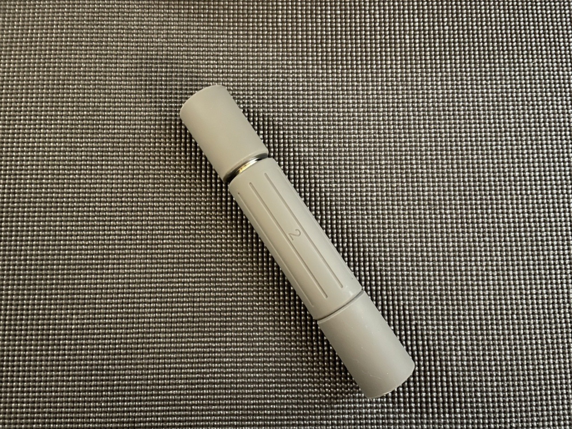 gray stakt weight on top of yoga mat, end stuck to base weight
