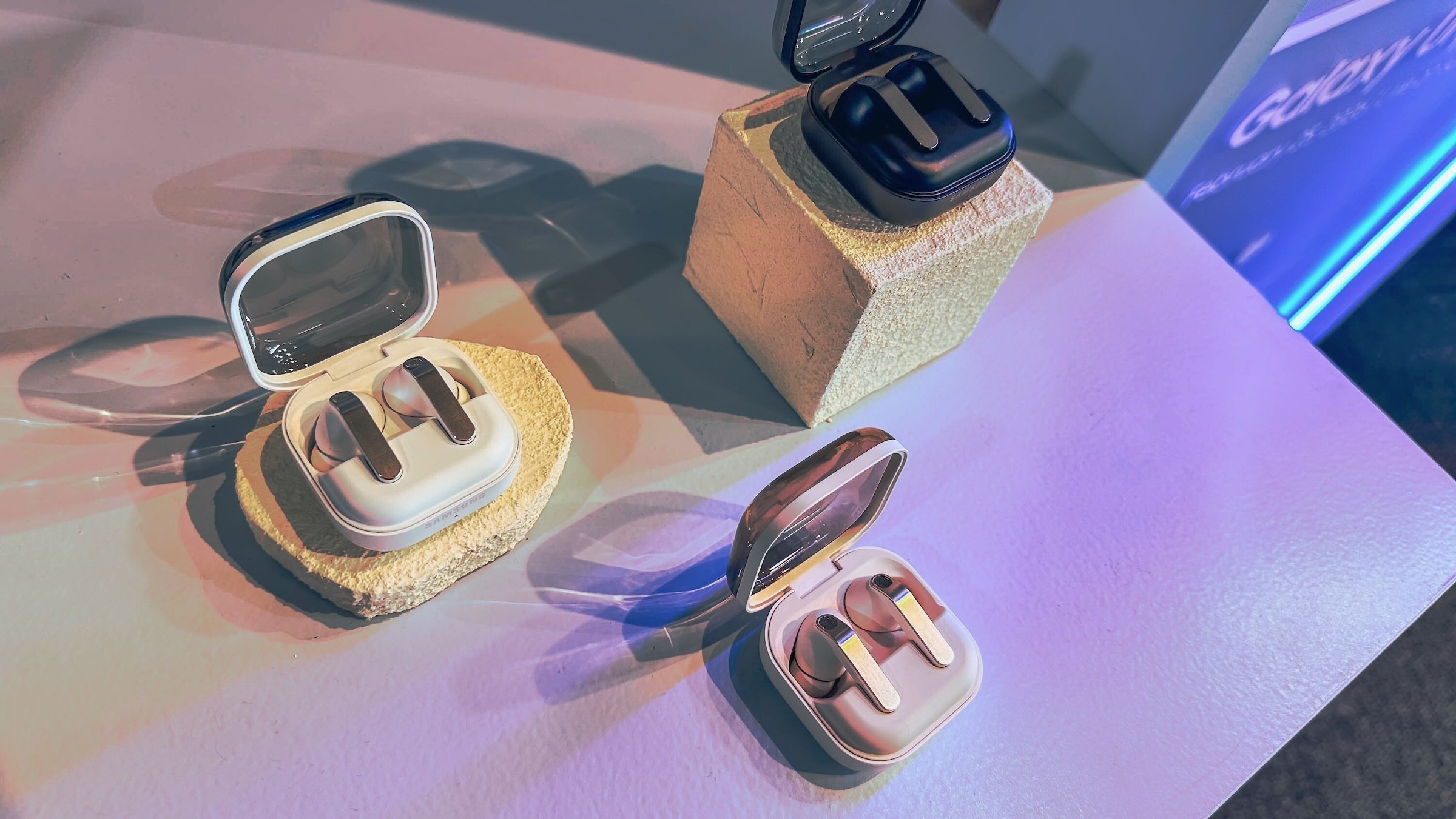 three pairs of samsung galaxy buds on display table