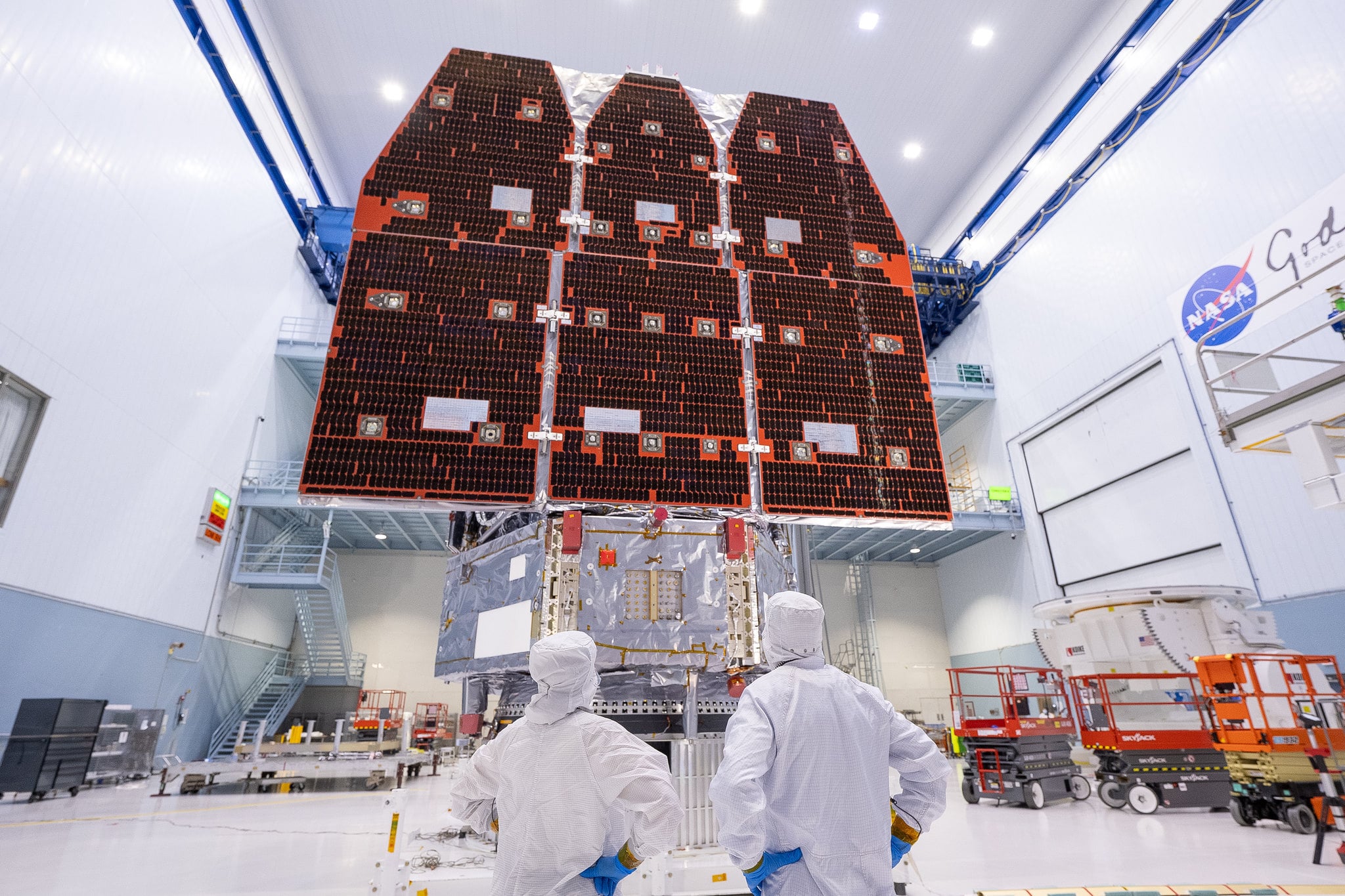 Technicians looking at the completed Nancy Grace Roman Space Telescope