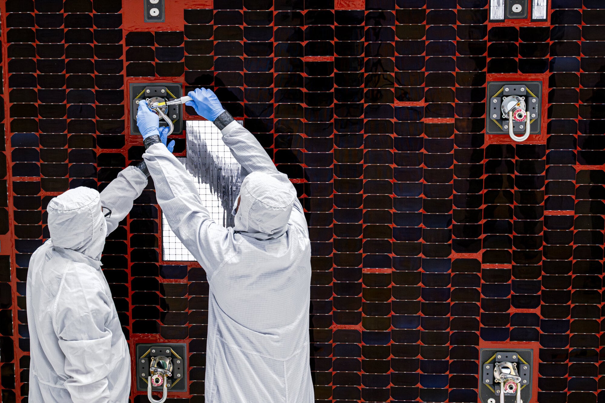 Technicians assembling the solar panels on the Nancy Grace Roman Space Telescope
