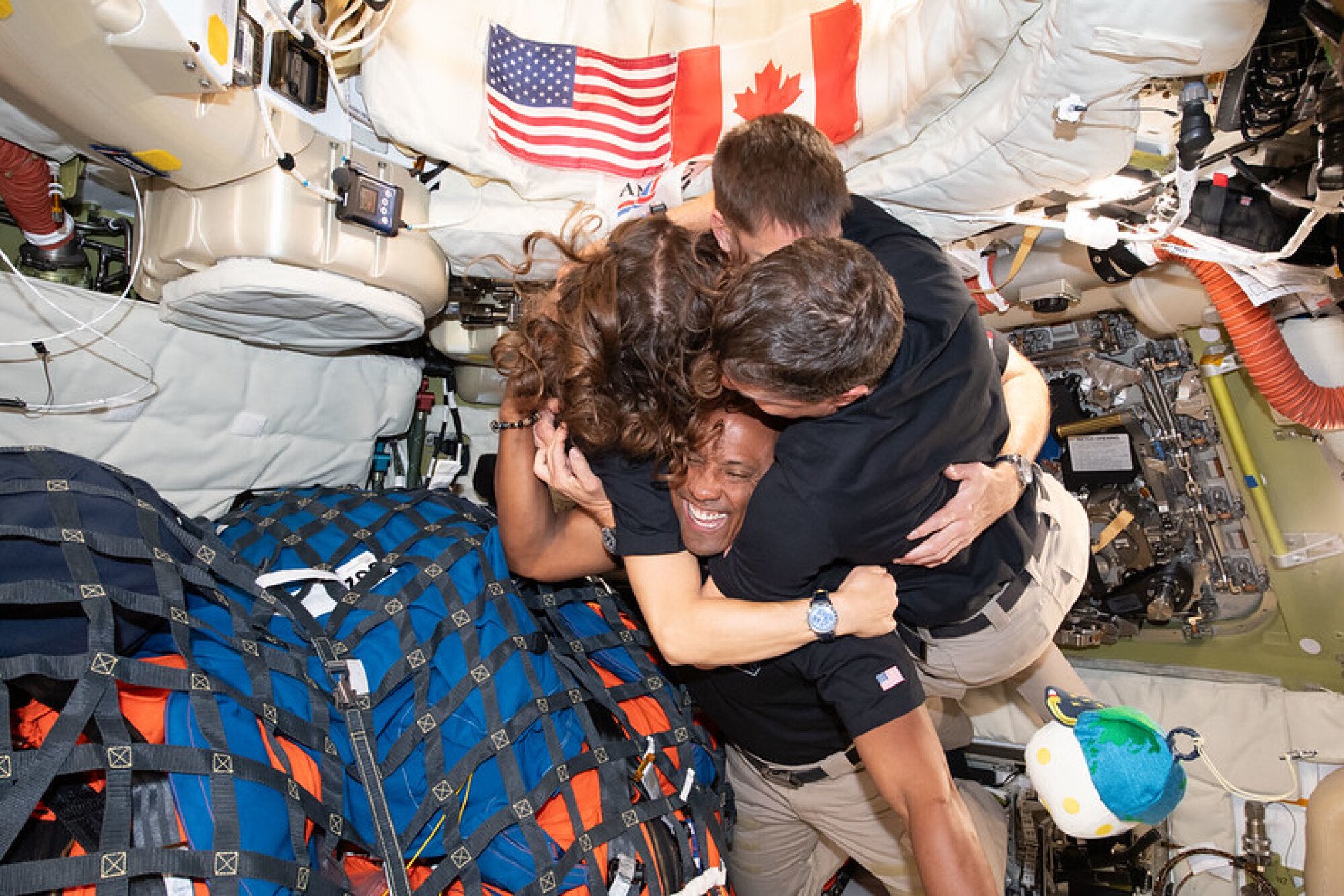 The Artemis II crew embracing in weightlessness during their deep space mission